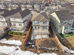 The property features a multi-level exterior with a deck and a lower patio area - 