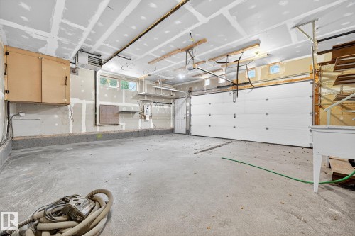 Oversized double ATTACHED garage make our winters more bearable. - 8860 93 Street, Edmonton, AB - Indoor Photo Showing Garage