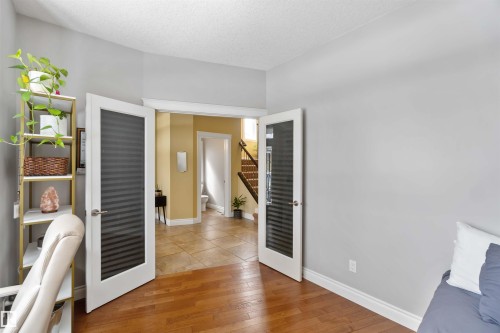 Room featuring wood-finish flooring, light grey walls, and a white ceiling - 10630 82 Street, Edmonton, AB - Indoor Photo Showing Other Room