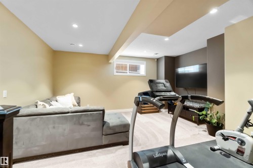 Recessed lighting illuminates this versatile lower-level space, featuring neutral-toned walls and light-colored carpet - 10630 82 Street, Edmonton, AB - Indoor
