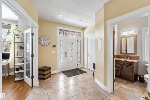 Entryway featuring tile flooring, a white front door with decorative glass inserts, and recessed lighting - 10630 82 Street, Edmonton, AB - Indoor