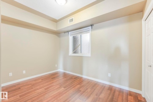 Unfurnished room featuring light wood-style flooring and baseboards - 310 10606 102 Avenue, Edmonton, AB - Indoor Photo Showing Other Room