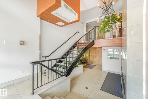 Staircase featuring tile patterned floors - 310 10606 102 Avenue, Edmonton, AB - Indoor Photo Showing Other Room