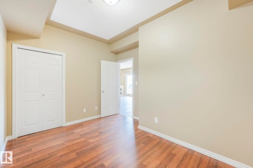 Unfurnished bedroom featuring wood finished floors and a closet - 310 10606 102 Avenue, Edmonton, AB - Indoor Photo Showing Other Room