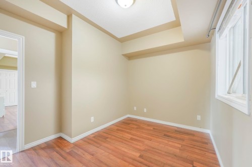Empty room featuring light wood finished floors and baseboards - 310 10606 102 Avenue, Edmonton, AB - Indoor Photo Showing Other Room