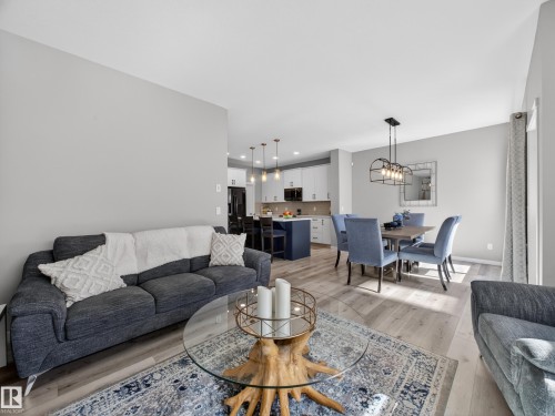 Spacious open-concept living area featuring light wood-finish flooring - 323 Balsam Link, Leduc, AB - Indoor Photo Showing Living Room