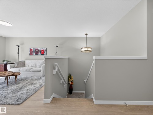 Spacious living area featuring light-toned walls, wood-finish flooring, and recessed lighting - 323 Balsam Link, Leduc, AB - Indoor Photo Showing Other Room