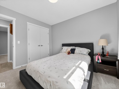 Bedroom featuring neutral grey walls and light-toned carpeting - 323 Balsam Link, Leduc, AB - Indoor Photo Showing Bedroom