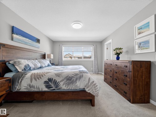 Carpeted room with light gray walls and a ceiling light fixture - 323 Balsam Link, Leduc, AB - Indoor Photo Showing Bedroom