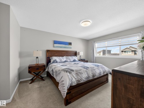 Carpeted room with light grey walls and a large window featuring white blinds - 323 Balsam Link, Leduc, AB - Indoor Photo Showing Bedroom