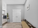 Entryway featuring light wood-finish flooring, light gray walls, and white bi-fold doors - 323 Balsam Link, Leduc, AB  - Indoor Photo Showing Other Room 