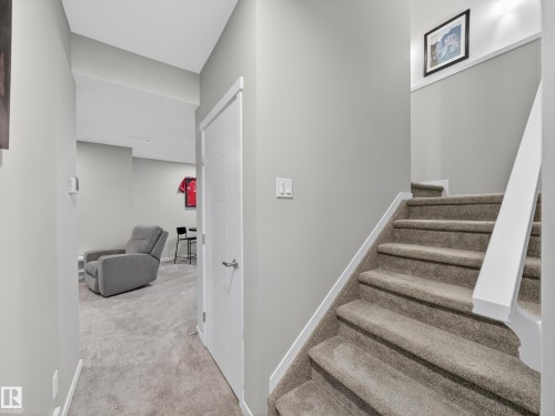Carpeted staircase with white balustrade leading to an upper level - 323 Balsam Link, Leduc, AB - Indoor Photo Showing Other Room