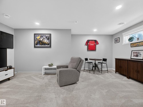 Spacious room featuring light gray carpeting, recessed lighting, and a window with blinds - 323 Balsam Link, Leduc, AB - Indoor Photo Showing Other Room