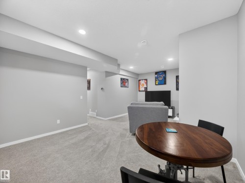 Spacious room featuring light gray walls, plush gray carpeting, and recessed lighting - 323 Balsam Link, Leduc, AB - Indoor