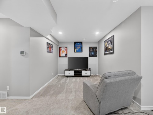 Finished basement area with recessed lighting, light gray walls, and patterned carpet flooring - 323 Balsam Link, Leduc, AB - Indoor Photo Showing Basement