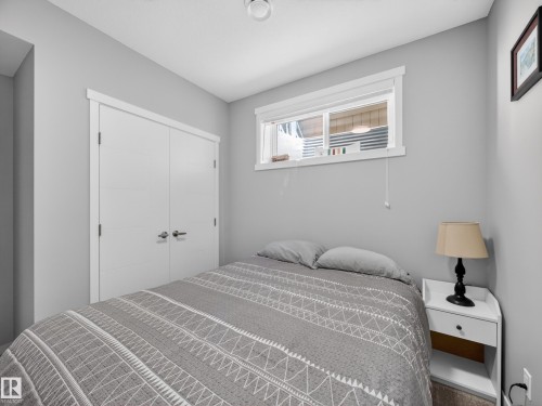 Neutral gray wall finishes complementing a contemporary interior - 323 Balsam Link, Leduc, AB - Indoor Photo Showing Bedroom