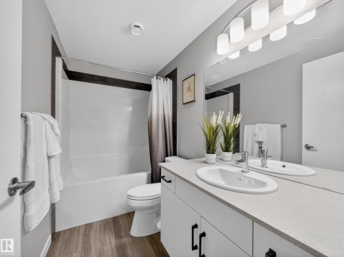 Dual vanity with integrated oval sinks and chrome fixtures - 323 Balsam Link, Leduc, AB - Indoor Photo Showing Bathroom