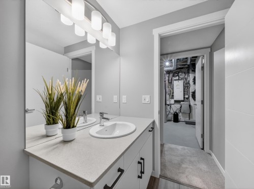 Contemporary vanity with a light gray countertop, integrated sink, and chrome faucet - 323 Balsam Link, Leduc, AB - Indoor Photo Showing Bathroom