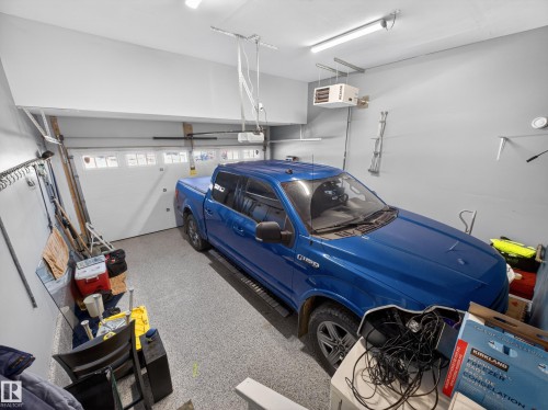 Single-car garage with a speckled epoxy floor finish - 323 Balsam Link, Leduc, AB - Indoor Photo Showing Garage