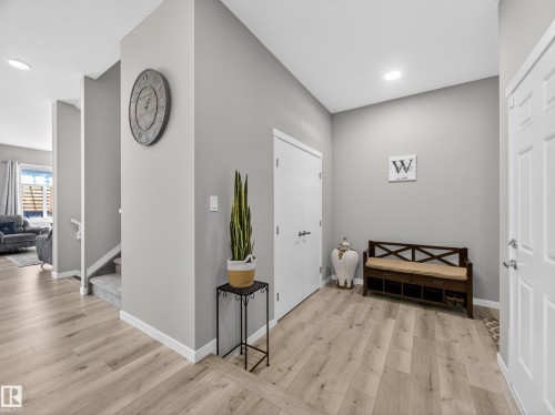 Entryway featuring light wood-finish flooring, recessed lighting, and a white paneled door - 323 Balsam Link, Leduc, AB - Indoor Photo Showing Other Room