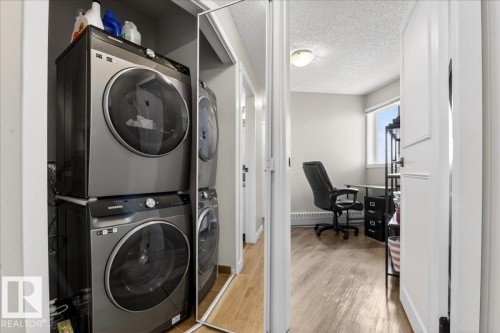 Stacking washer and dryer are just a year old - 210 11620 9A Avenue, Edmonton, AB - Indoor Photo Showing Laundry Room