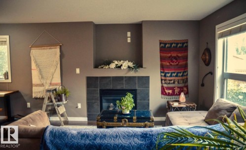 Living room with a tiled fireplace and wood finished floors - 12246 103 Street Nw, Edmonton, AB - Indoor Photo Showing Living Room With Fireplace