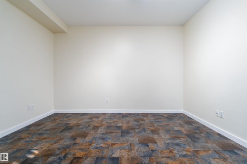 Empty room with stone finish flooring and baseboards - 12246 103 Street Nw, Edmonton, AB - Indoor Photo Showing Other Room