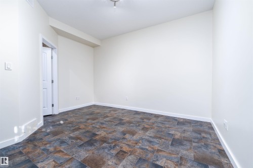 Unfurnished room featuring stone finish flooring - 12246 103 Street Nw, Edmonton, AB - Indoor Photo Showing Other Room