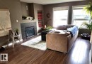 Living room at the main floor with dark wood-style floors and a fireplace - 12246 103 Street Nw, Edmonton, AB  - Indoor Photo Showing Living Room With Fireplace 