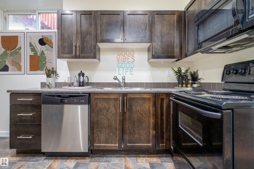Kitchen with black appliances and dark brown cabinetry - 12246 103 Street Nw, Edmonton, AB - Indoor Photo Showing Kitchen