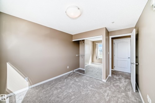 Neutral-toned walls complement the gray carpeting - 344 1520 Hammond Gate Gate, Edmonton, AB - Indoor Photo Showing Other Room