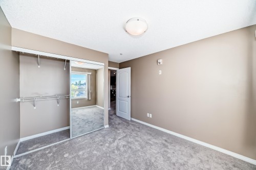 Bedroom featuring neutral wall paint, gray carpet flooring, and white trim - 344 1520 Hammond Gate Gate, Edmonton, AB - Indoor Photo Showing Other Room