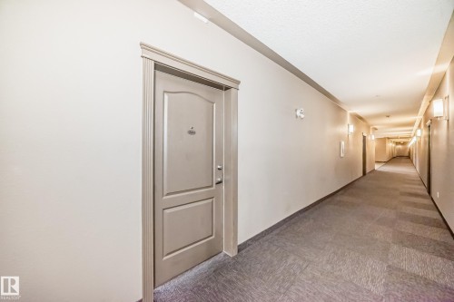 Hallway with grey patterned carpeting and light-colored walls - 344 1520 Hammond Gate Gate, Edmonton, AB - Indoor Photo Showing Other Room