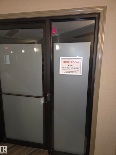 Frosted glass entry doors with dark framing and a complementary trim - 344 1520 Hammond Gate Gate, Edmonton, AB - Indoor Photo Showing Other Room
