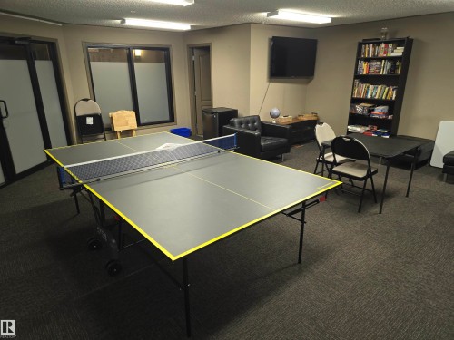 Recreation room featuring a ping-pong table and dark gray carpet flooring - 344 1520 Hammond Gate Gate, Edmonton, AB - Indoor Photo Showing Other Room