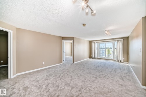 Spacious room with light-colored carpeting and neutral wall tones - 344 1520 Hammond Gate Gate, Edmonton, AB - Indoor Photo Showing Other Room