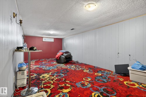 Spacious interior with full carpeting and paneled walls - 9112 130 Avenue, Edmonton, AB - Indoor Photo Showing Bedroom