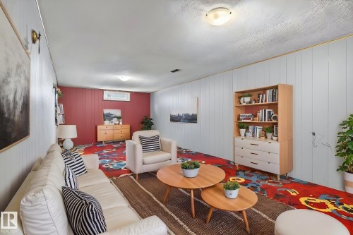 Lower-level room featuring paneling walls and a textured ceiling - 9112 130 Avenue, Edmonton, AB - Indoor