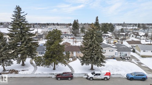 Residential property with a single-story home featuring light-colored siding and a dark shingle roof - 9112 130 Avenue, Edmonton, AB - Outdoor With View