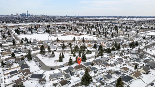 Residential neighborhood featuring a mix of single-story and multi-story homes with individual driveways and rooflines - 9112 130 Avenue, Edmonton, AB - Outdoor With View
