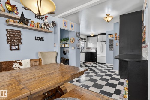 Dining area with built-in shelving, featuring a wood-finish dining surface - 9112 130 Avenue, Edmonton, AB - Indoor Photo Showing Dining Room