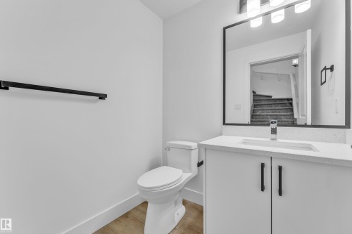 Modern vanity with white cabinetry, rectangular undermount sink, and a speckled white countertop - 277 Munn Way, Leduc, AB - Indoor Photo Showing Bathroom
