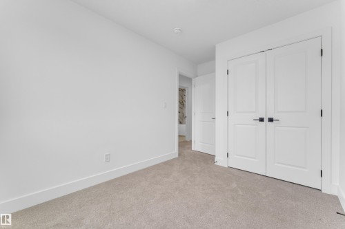Room featuring neutral-toned carpet, white walls, and bright white baseboards - 277 Munn Way, Leduc, AB - Indoor Photo Showing Other Room