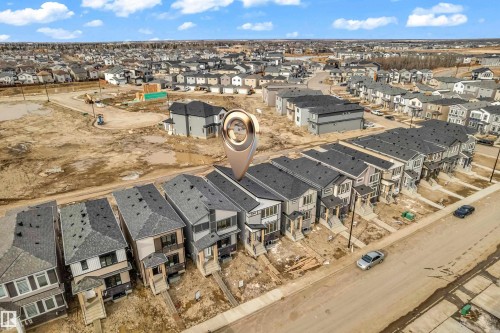 Newly constructed multi-story residences featuring contemporary exterior finishes including siding and stone accents - 277 Munn Way, Leduc, AB - Outdoor With View