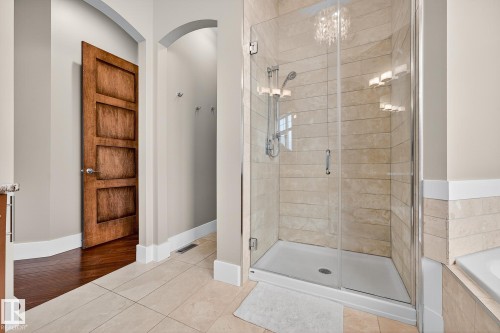 Bathroom featuring a bath, light tile patterned floors, and a stall shower - 940 Haliburton Road, Edmonton, AB - Indoor Photo Showing Bathroom