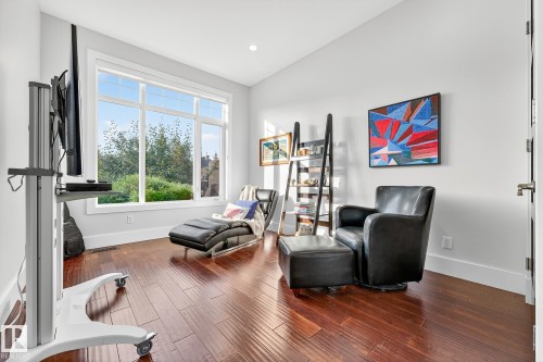 Sitting room featuring dark wood-style flooring and recessed lighting - 940 Haliburton Road, Edmonton, AB - Indoor