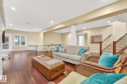 Living room with wood finished floors, recessed lighting, and stairway - 940 Haliburton Road, Edmonton, AB - Indoor Photo Showing Living Room
