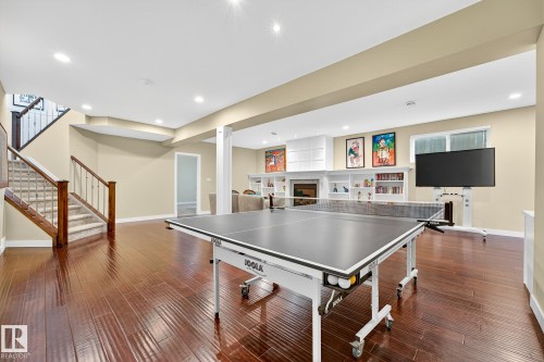 Game room featuring dark wood-style flooring, recessed lighting, and a fireplace - 940 Haliburton Road, Edmonton, AB - Indoor Photo Showing Other Room