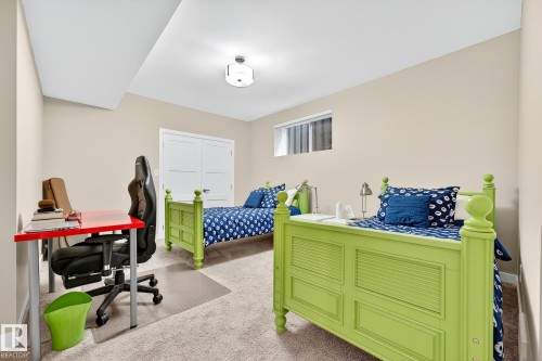 Bedroom featuring a desk, light carpet, and a closet - 940 Haliburton Road, Edmonton, AB - Indoor