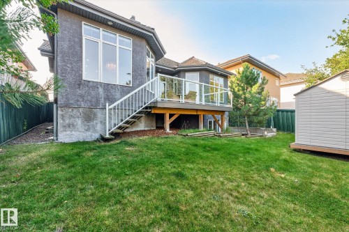 Rear view of house with stairway, a wooden deck, a shed, and stucco siding - 940 Haliburton Road, Edmonton, AB - Outdoor With Deck Patio Veranda With Exterior